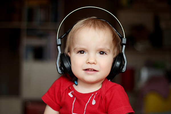 A child wears headphones and looks forward