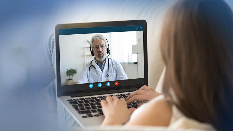 A patient meets with a doctor in a telehealth visit